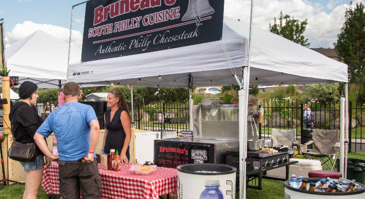 Contact Bruneau's Food Cart for Catering or Events. The owner stands in front of the food cart serving people in Bend Oregon